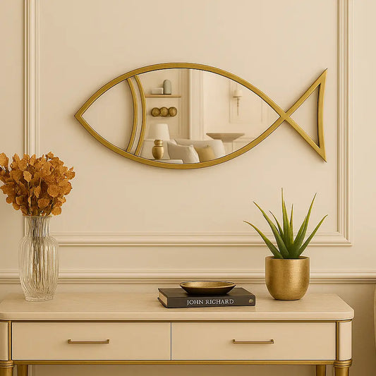 Decorative console table with a gold fish mirror above, featuring a vase, book, and plant.