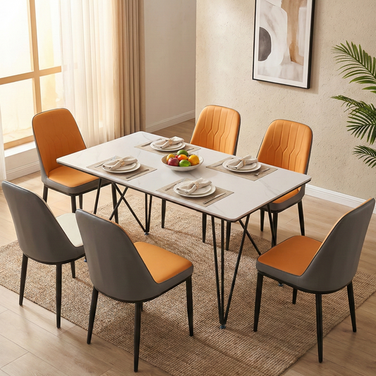 Dining room with a table and chairs featuring orange and gray seats.