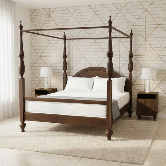 Wooden four-poster bed in a bedroom with geometric wallpaper